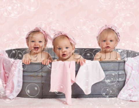 Three toddlers in metal bath