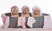 Three toddlers in flowery bonnets